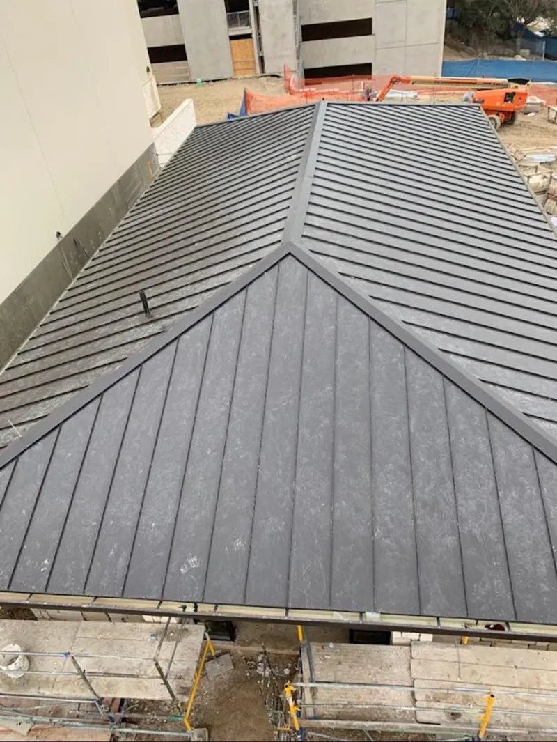 Commercial metal roof construction with crane equipment in Allamuchy